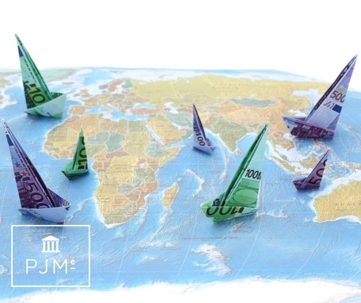 money rolled up as sail ships