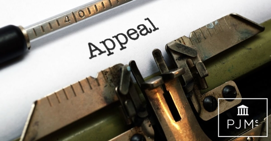 typewriter and paper with the word appeal written on it