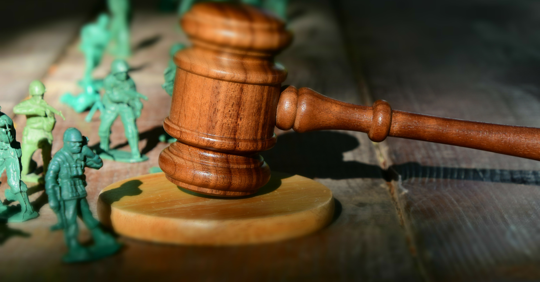 toy army men next to judges gavel